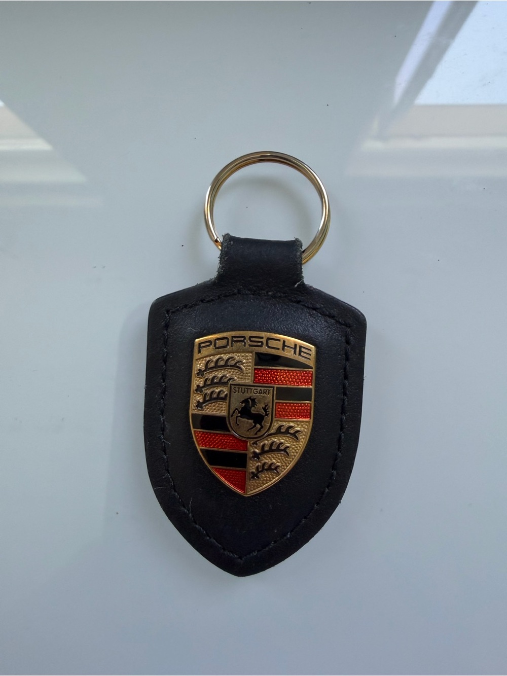 Porsche Design Black Leather Shield Keychain with Gold Crest